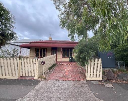 A house with a fence and trees

Description automatically generated