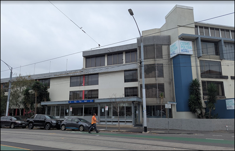 A building with cars parked on the side of the street

AI-generated content may be incorrect.