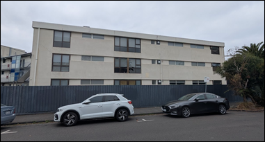 A white car parked in front of a building

AI-generated content may be incorrect.