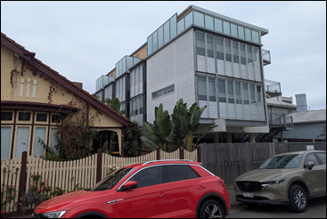 A red car parked in front of a building

AI-generated content may be incorrect.